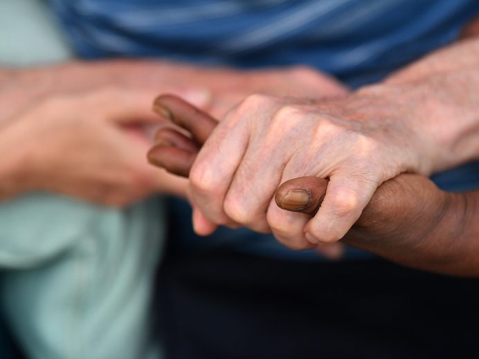 Carer holding a resident's hands